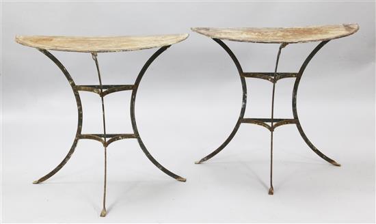 A pair of early 20th century French wrought iron and zinc console tables, W.2ft 6in. D.1ft 2in. H.2ft 4in.